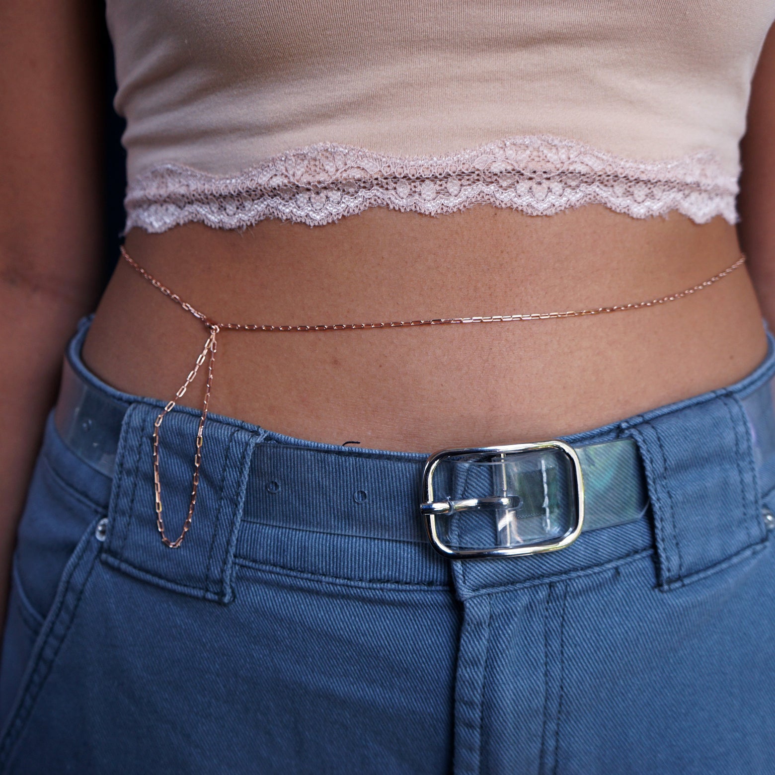 Close up view of a model wearing a 14k rose gold Wrap Necklace worn as a belly chain