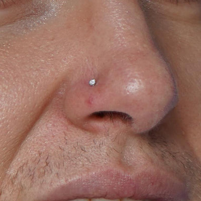 A model's nose wearing a 14 karat gold Diamond Nose Stud