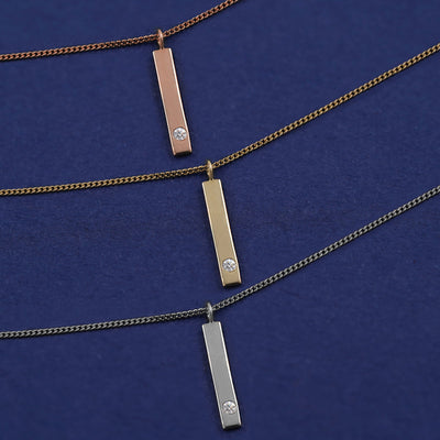 Three Diamond Bar Necklaces shown in options of rose, yellow, and white gold