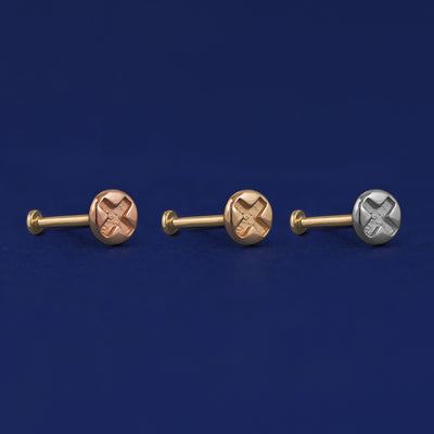 Three versions of the Screw Flat Back Earring shown in options of rose, yellow, and white gold