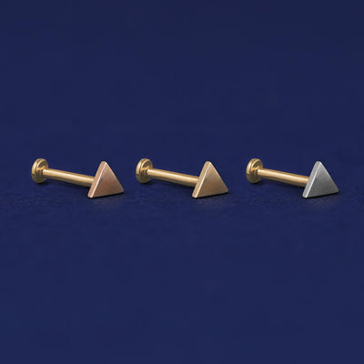 Three versions of the Triangle Flat Back Earring shown in options of rose, yellow, and white gold