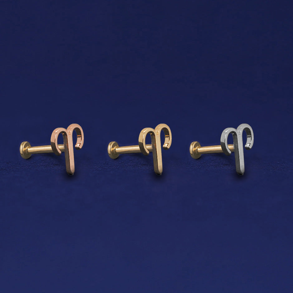 Three versions of the Aries Horoscope Flat Back Piercing shown in options of rose, yellow, and white gold