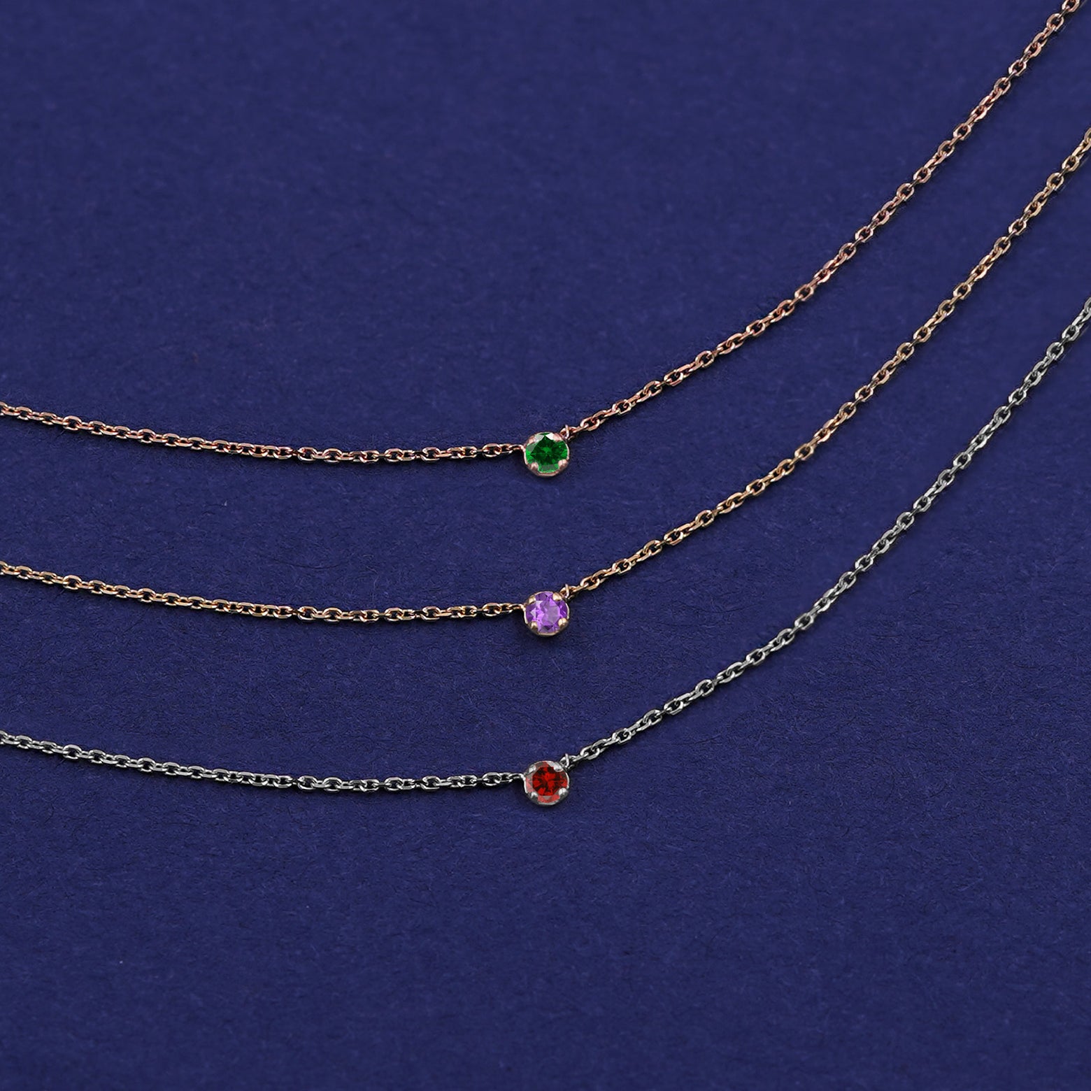 Three Gemstone Cable Necklaces shown in options of rose, yellow, and white gold