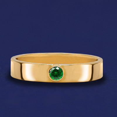 A solid yellow gold Emerald Gemstone Industrial ring