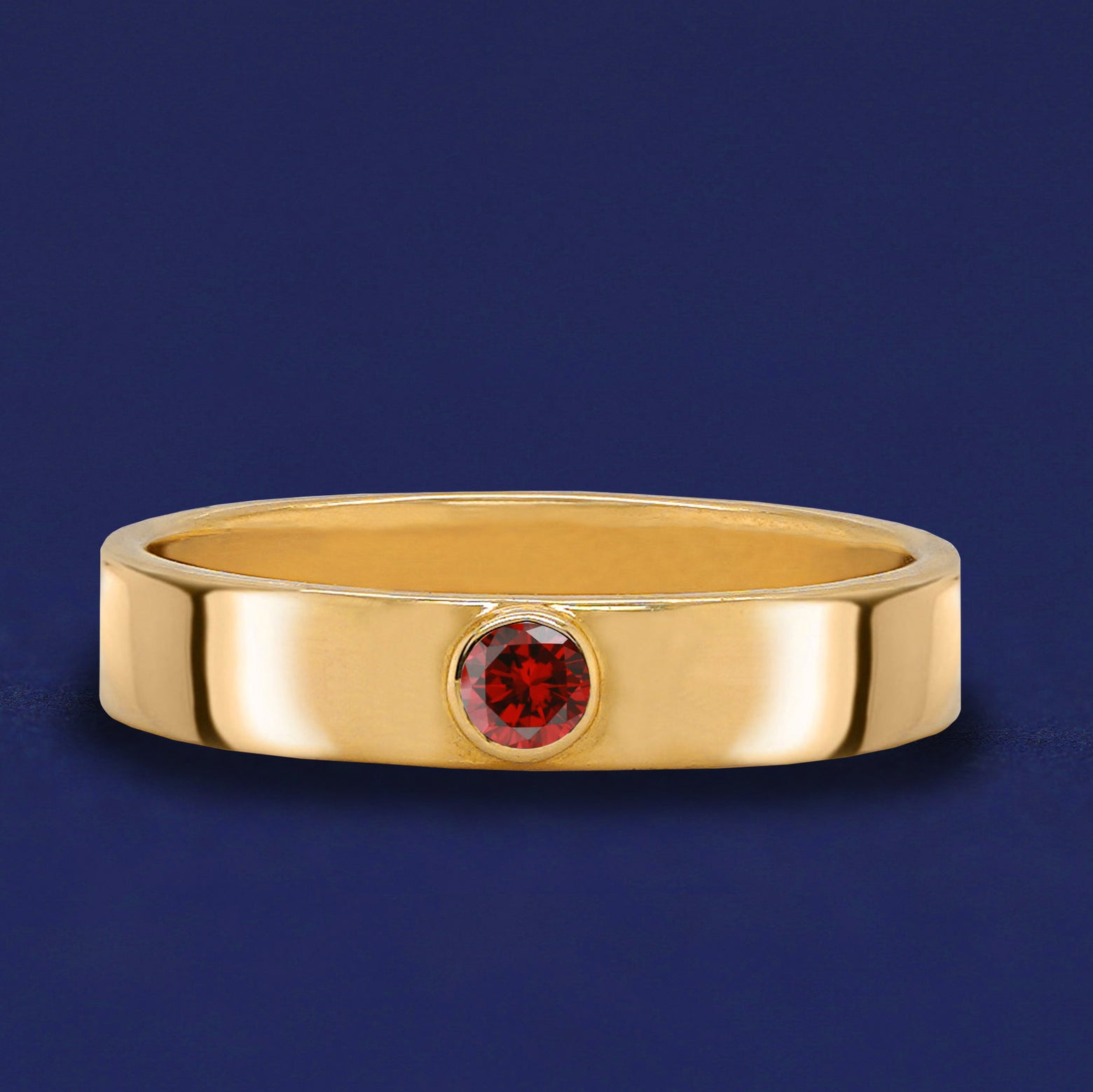 A solid yellow gold Garnet Gemstone Industrial ring