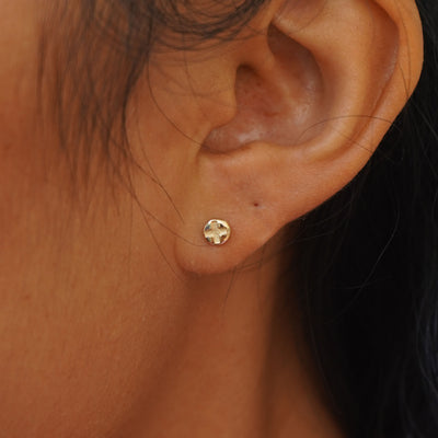 A model's ear wearing a yellow gold Screw Earring