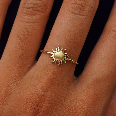 Close up view of a model's hand wearing a yellow gold Sun Ring