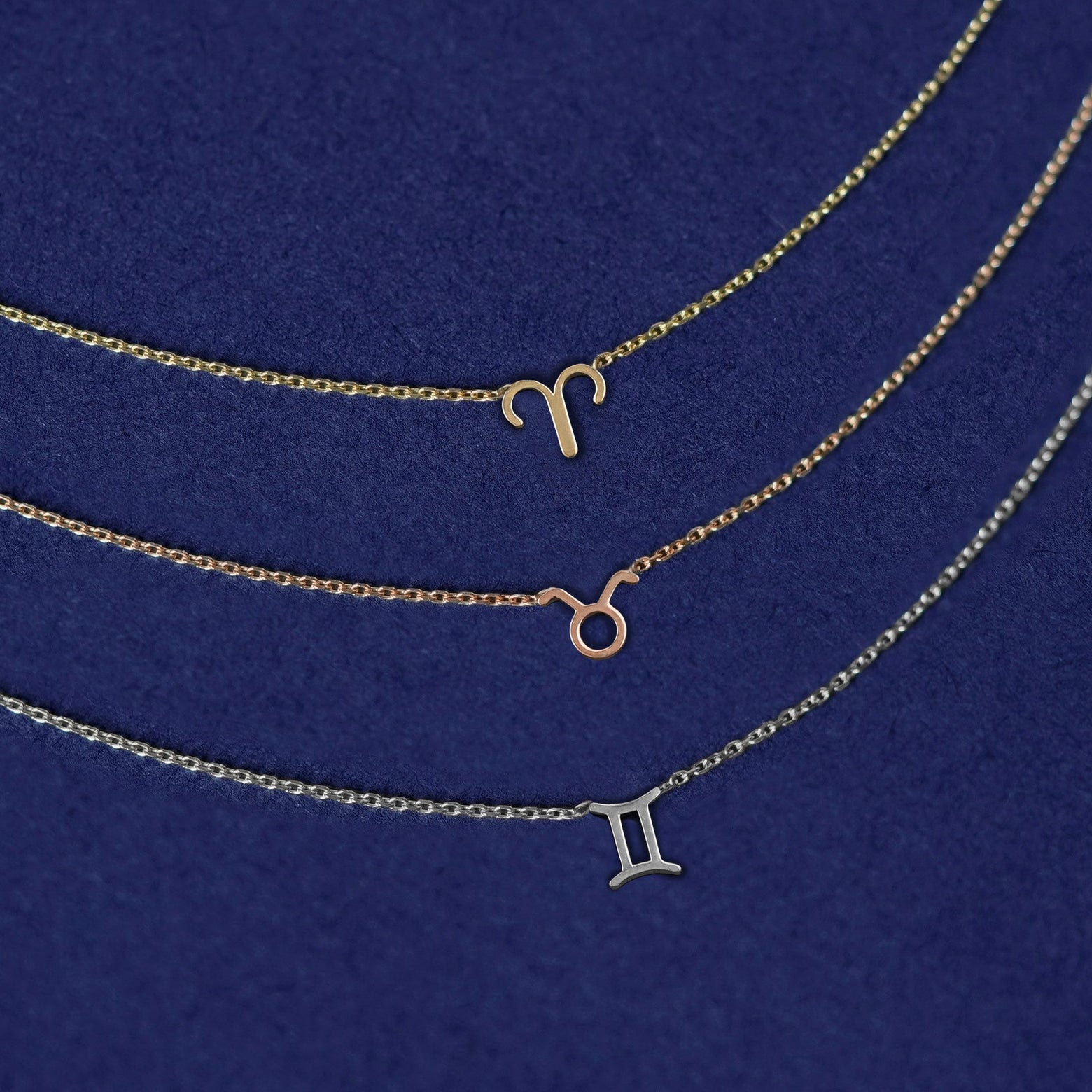 Three Horoscope Cable Necklaces in zodiac symbols of Aries, Taurus and Gemini in yellow, rose, and white gold respectively