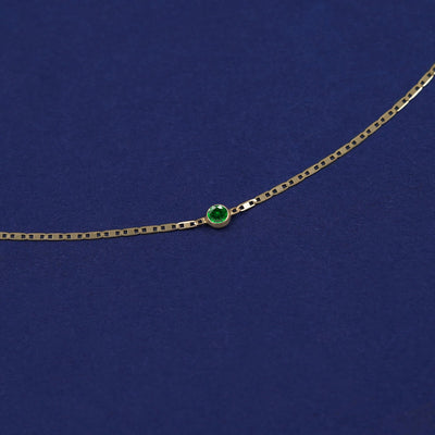 Bezel set Emerald gemstone solitaire on a 14 karat gold Valentine chain bracelet