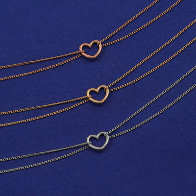 Three Heart Bracelets shown in options of rose, yellow, and white gold
