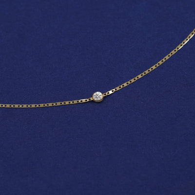 Bezel set Moissanite solitaire on a 14 karat gold Valentine chain bracelet