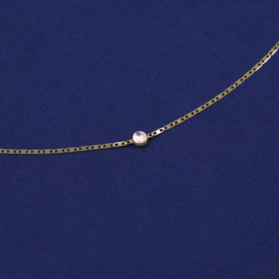 Bezel set Moonstone gemstone solitaire on a 14 karat gold Valentine chain bracelet