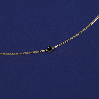 Bezel set Onyx gemstone solitaire on a 14 karat gold Valentine chain bracelet