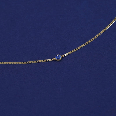 Bezel set Blue Sapphire gemstone solitaire on a 14 karat gold Valentine chain bracelet