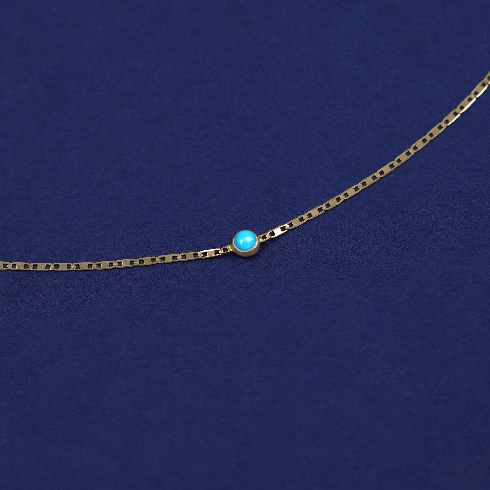 Bezel set Turquoise gemstone solitaire on a 14 karat gold Valentine chain bracelet