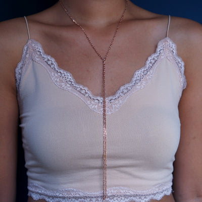 Close up view of a model wearing a 14k rose gold Wrap Necklace worn as a lariat necklace