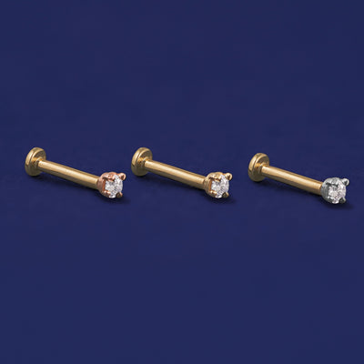 Three versions of the 2mm Diamond Flat Back Earring shown in options of rose, yellow, and white gold
