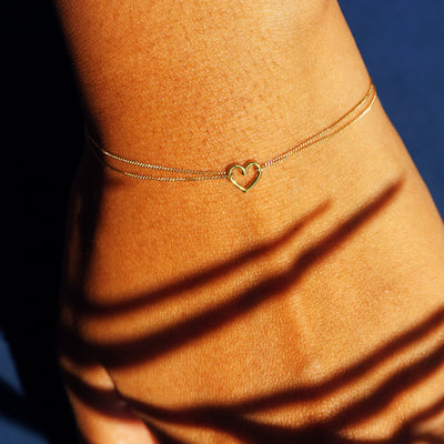 Alternate view of a model's wrist wearing a yellow gold Heart Bracelet