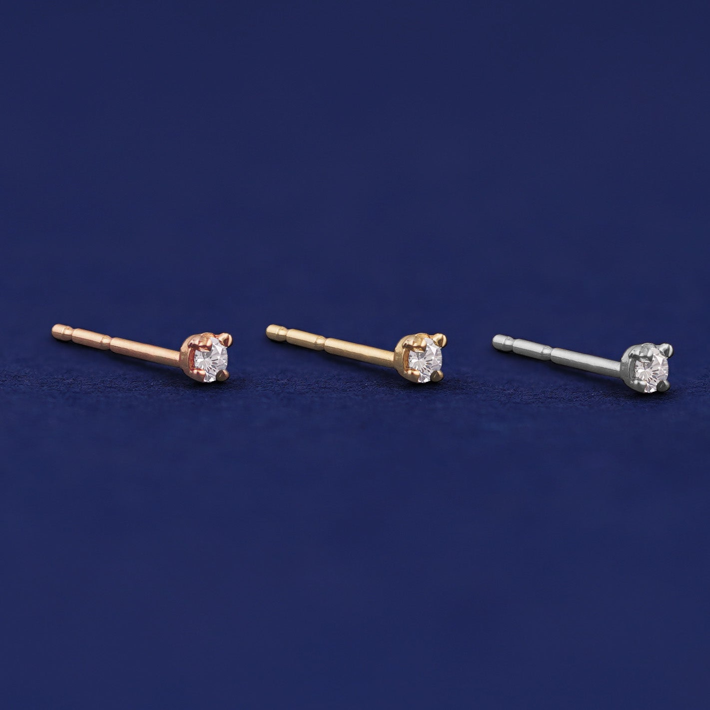 Three versions of the 2mm Diamond Earring shown in options of rose, yellow, and white gold