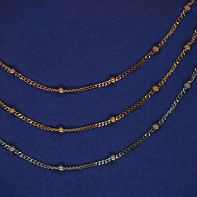 Three versions of the Beads Anklet shown in options of rose, yellow, and white gold
