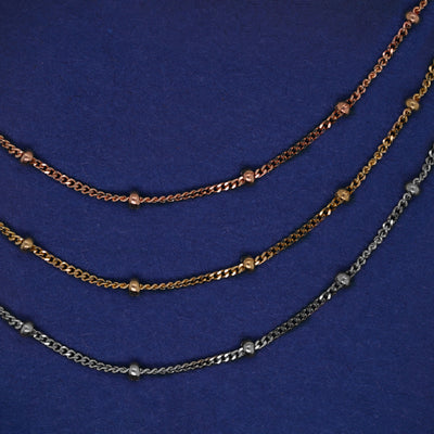 Three versions of the Beads Bracelet shown in options of rose, yellow, and white gold