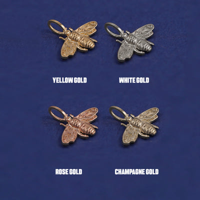 Four versions of the Bee Charm shown in options of yellow, white, rose and champagne gold