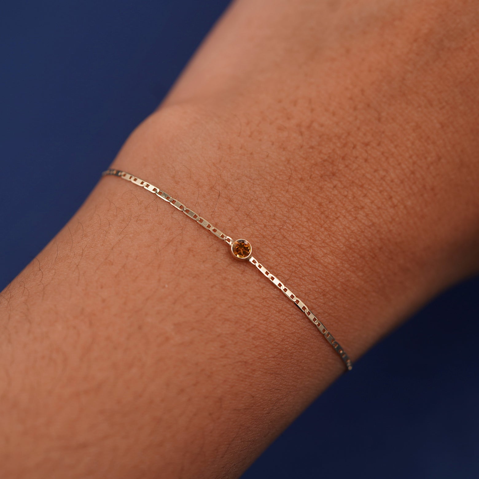 A models wrist wearing 14k yellow gold Citrine Bracelet