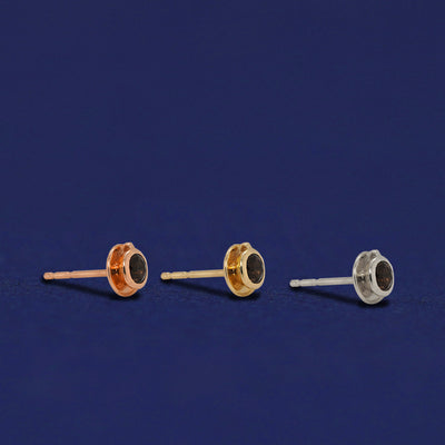Three versions of the Coffee Cup Earrings shown in options of rose, yellow, and white gold