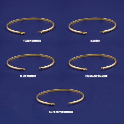 Five versions of the solid gold Diamond Open Bangle showing Yellow , Clear, Black, Champagne, and Salt and Pepper diamonds