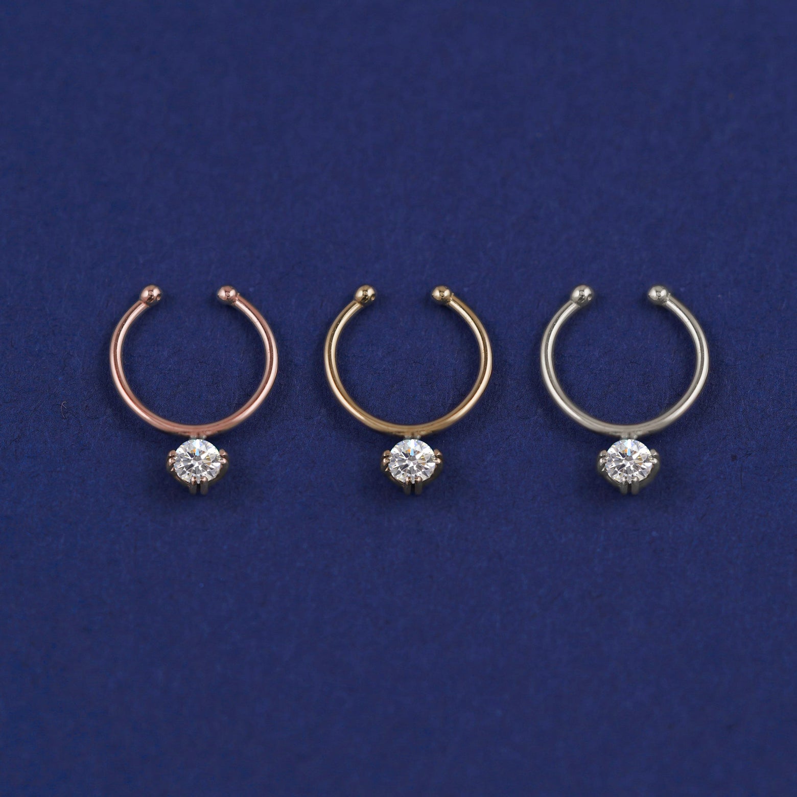Three versions of the Non-Pierced Diamond Septum shown in options of rose, yellow, and white gold