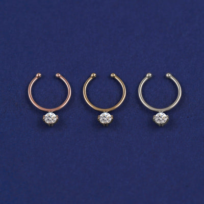 Three versions of the Non-Pierced Diamond Septum shown in options of rose, yellow, and white gold