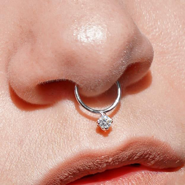 Close up view of a model's nose wearing a yellow gold Diamond Septum
