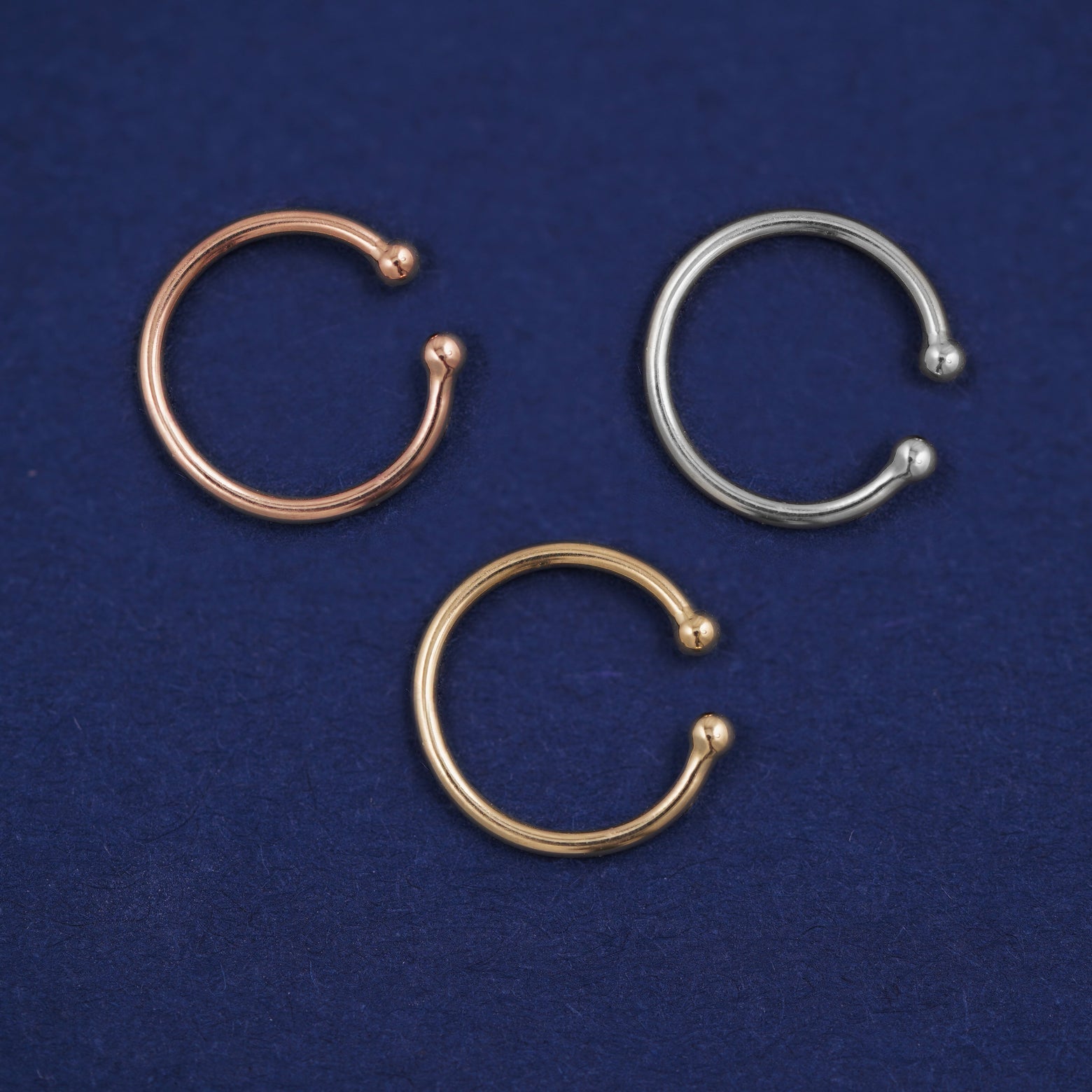 Three versions of the Line Cuff shown in options of rose, white, and yellow gold