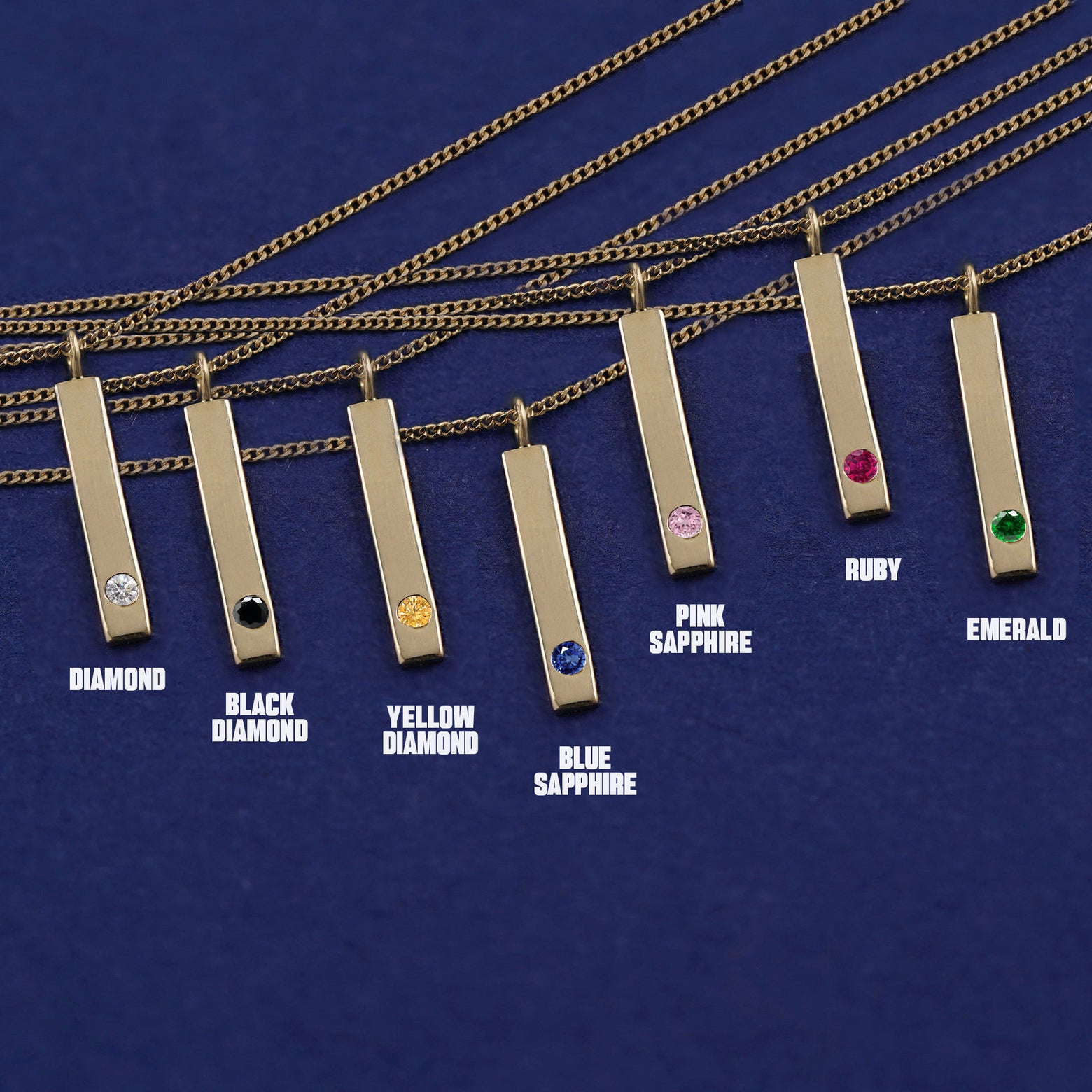 Seven versions of the Gemstone Bar Necklace showing all the gemstone options laid out on a dark blue background