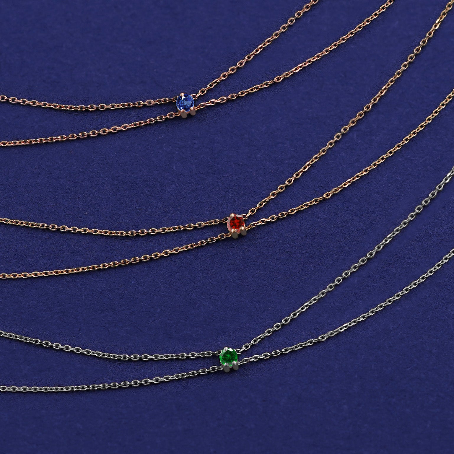 Three Gemstone Cable Bracelets shown in options of rose, yellow, and white gold