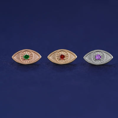 Three versions of the Gemstone Evil Eye Earring shown in options of rose, yellow, and white gold