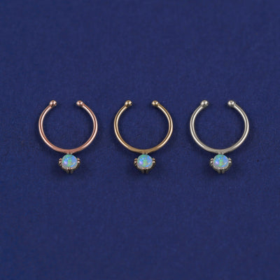 Three versions of the opal Non-Pierced Gemstone Septum shown in options of rose, yellow, and white gold