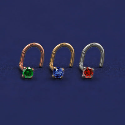 Three versions of the Gemstone Nose Stud shown in options of rose, yellow, and white gold