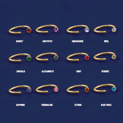 Twelve versions of the solid gold Gemstone Open Hoop showing the different stone options