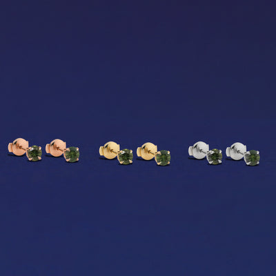 Three pairs of Green Sapphire Pressure Lock Earrings shown in options of rose, yellow, and white gold