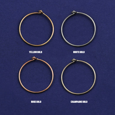 Four versions of the Medium Hoop shown in options of yellow, white, rose and champagne gold