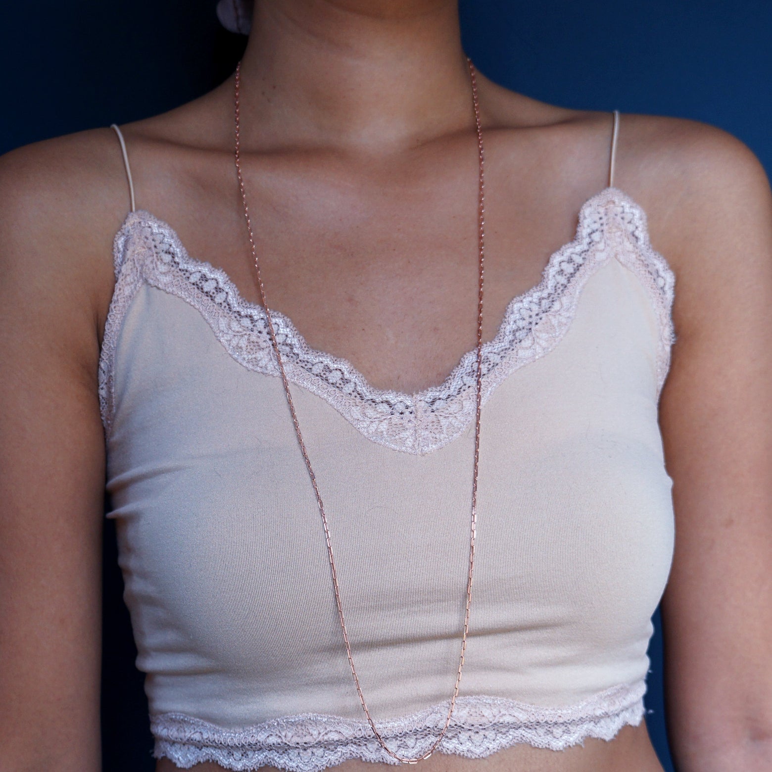 Close up view of a model wearing a 14k rose gold Wrap Necklace to its full length