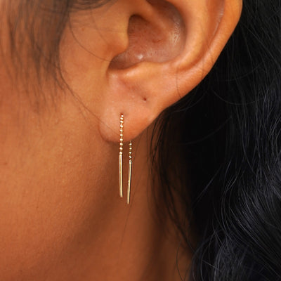 Close up view of a model's ear wearing a Mini Threader