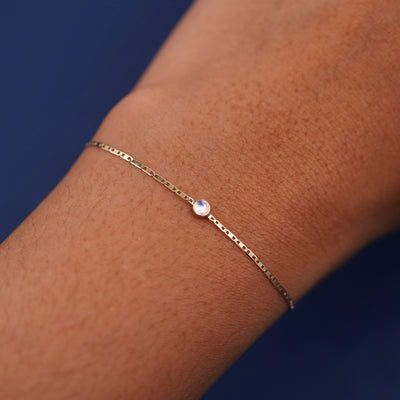 A models wrist wearing 14k yellow gold Moonstone Bracelet