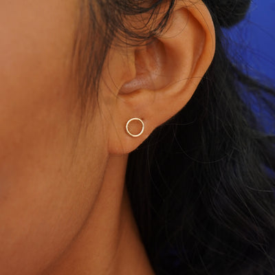 Close up view of a model's ear wearing a yellow gold Open Circle Earring
