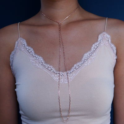 Close up view of a model wearing a 14k rose gold Wrap Necklace worn as a lariat choker necklace