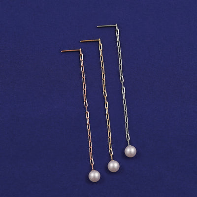 Three versions of the Pearl Dangle Earring shown in options of rose, yellow, and white gold