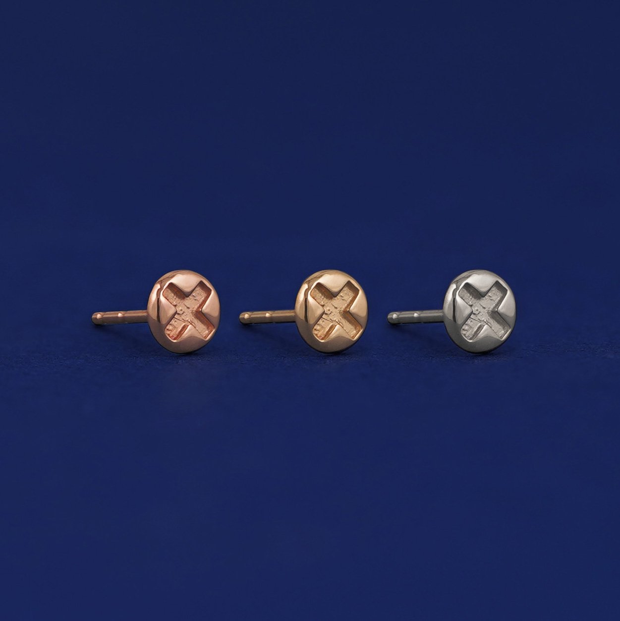 Three versions of a Screw Earring shown in options of rose, yellow, and white gold