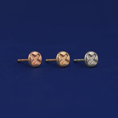 Three versions of a Screw Earring shown in options of rose, yellow, and white gold