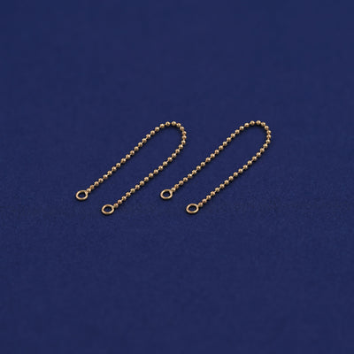 Two yellow gold Connectors laid out to show detail